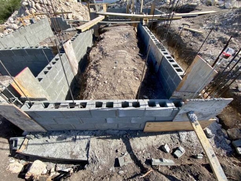 Concrete foundation installation with block walls and framing setup on the construction site in Chagrin Falls, OH