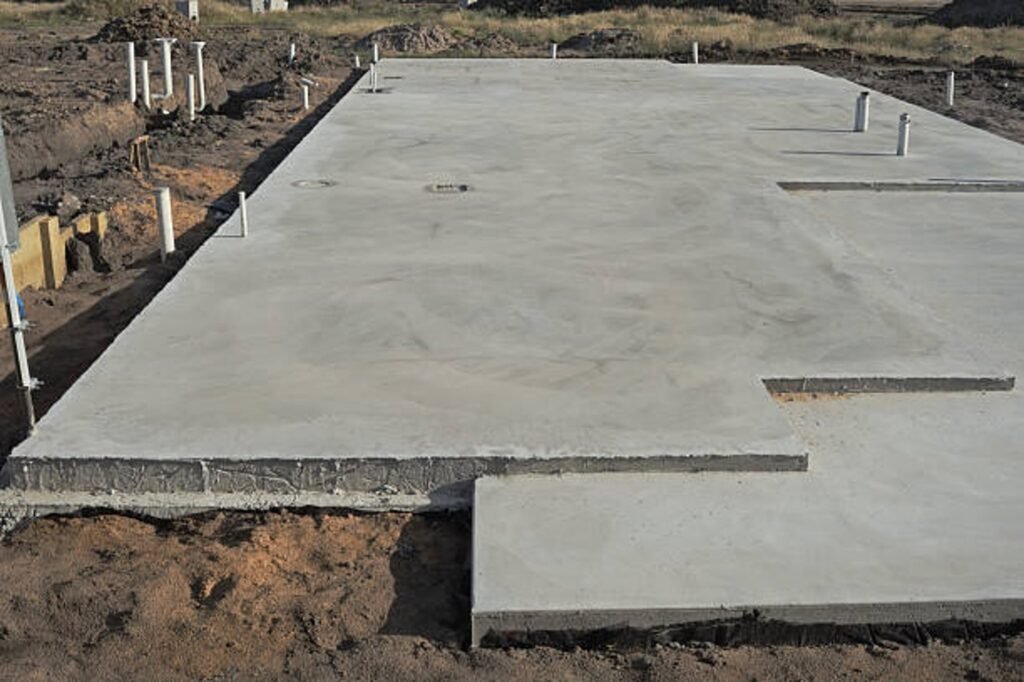 Newly poured concrete slab foundation with smooth finish and structural layout in Chagrin Falls, OH