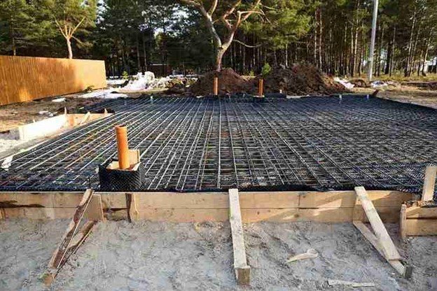 Concrete slab preparation with steel rebar reinforcement grid before pouring foundation in Beachwood, OH